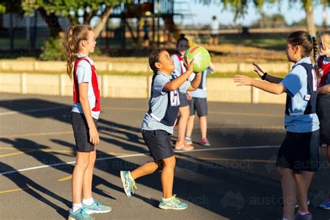 Image of School children playing netball - Austockphoto