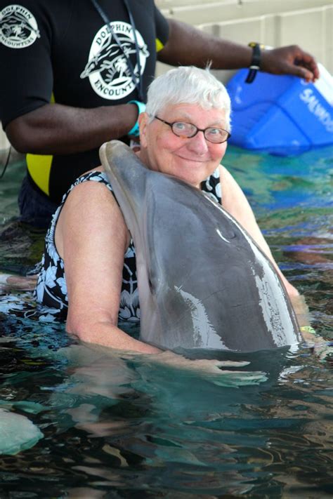 Sweet dolphin hug at Dolphin Encounters, Blue Lagoon Island, Bahamas ...