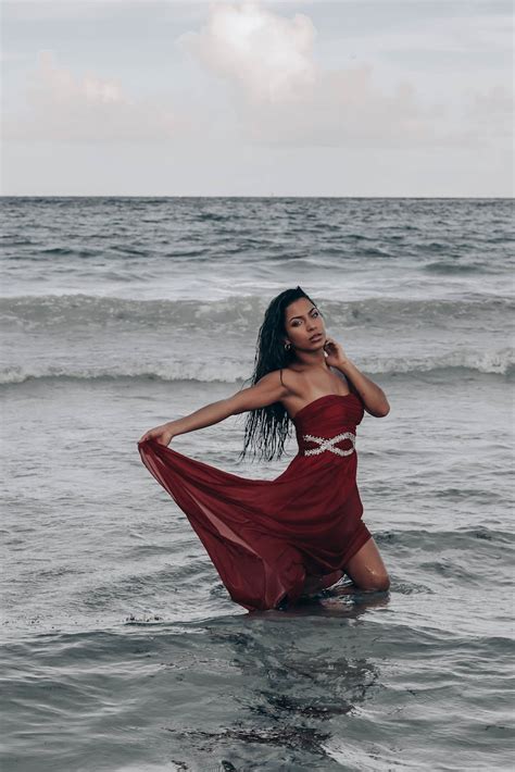 Graceful ethnic woman in wet maxi dress standing in seawater · Free ...