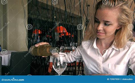 Smiling Pretty Blonde Woman Pouring a Large Glass of Wine in Her Hand Stock Video - Video of ...