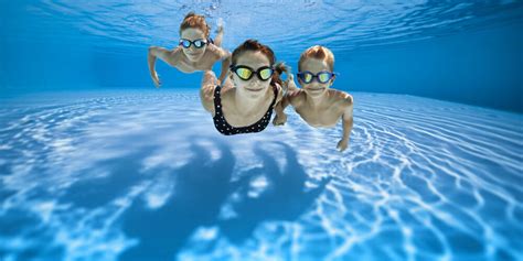 Three happy kids swimming underwater in pool | Pool Troopers