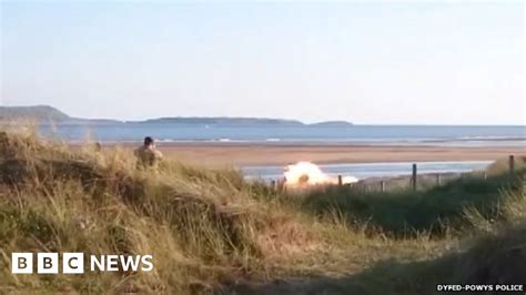 Burry Port beach reopens after washed-up mine is blown up - BBC News