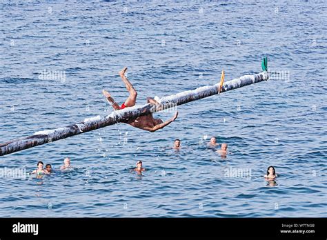 Xghajra, Malta - August 3, 2019: Traditional Maltese game of Gostra, where is Brave local men ...