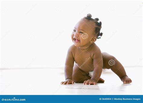 Baby Crawling Indoors Smiling Stock Images - Image: 5640004