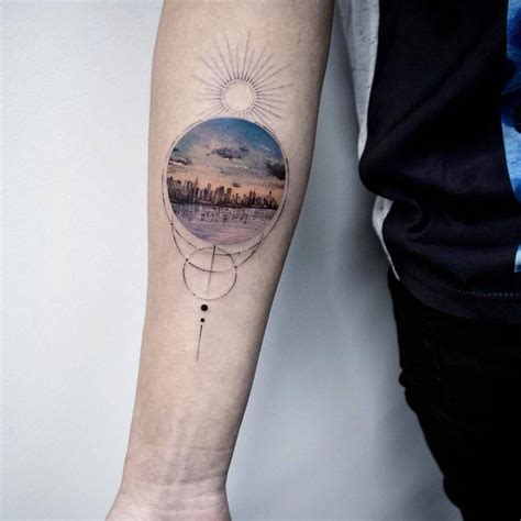 New York Skyline tattoo on the right inner forearm.