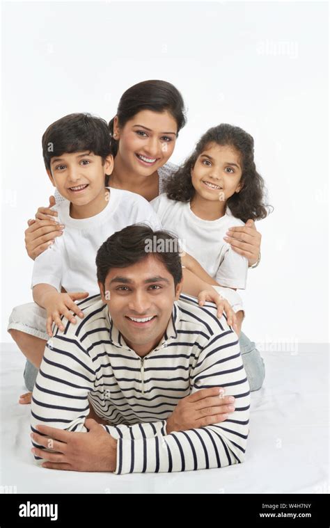 Portrait of an Indian family smiling on the bed Stock Photo - Alamy