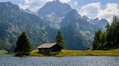 Premium AI Image | a cabin by a mountain lake