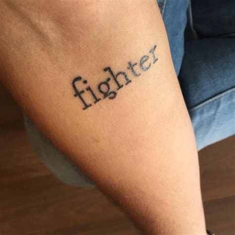 Forearm tattoo saying 'fighter' on Fabrizio.