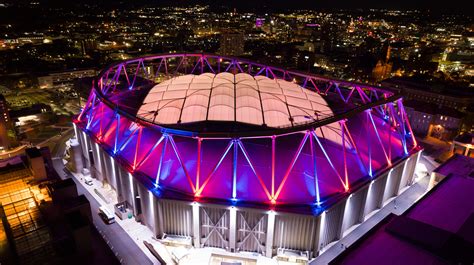 An aerial shot of the Syracuse University Stadium lit up at night ...