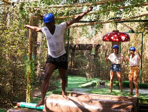 Team of Friends Overcomes an Obstacle Course in an Amusement Park Stock Photo - Image of sunny ...