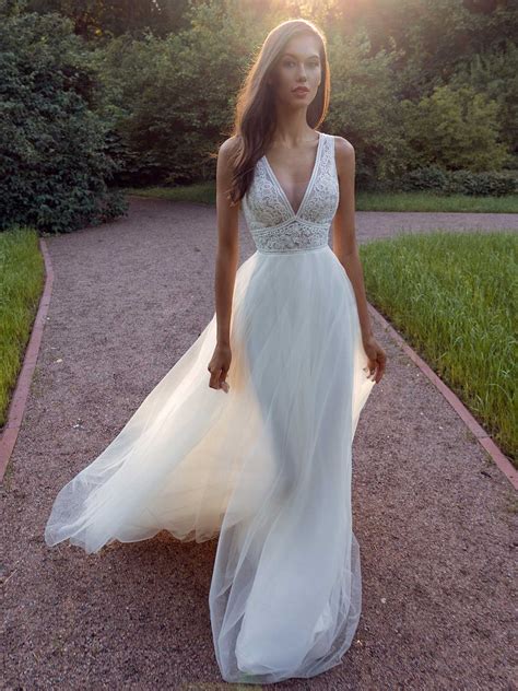 A-line wedding dress with a deep V-neckline lace bodice and illusion back