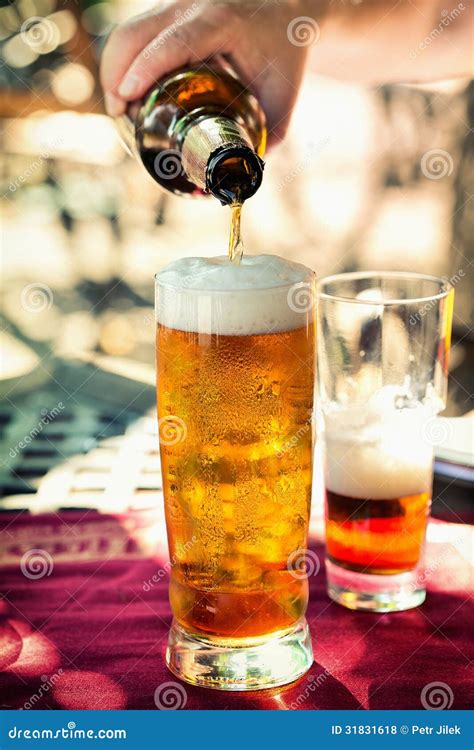 Beer pouring into glass stock photo. Image of brown, light - 31831618