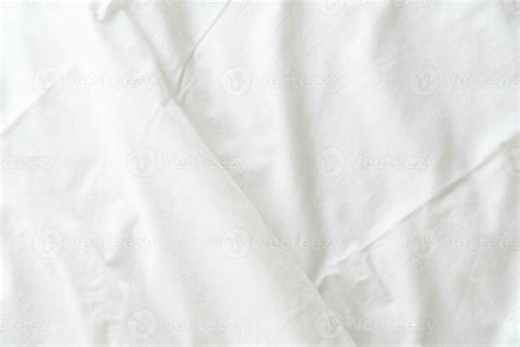 Abstract pattern of white crumpled bed sheet. White wrinkled fabric texture rippled surface ...