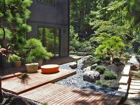 a wooden deck surrounded by plants and rocks