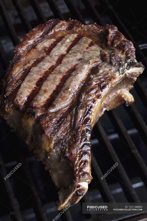 T-bone steak on grill — t bone, nutrition - Stock Photo | #157148890