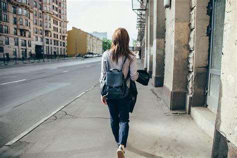 Back view of a hipster girl walking on city street. - Edgewood Center for Children and Families