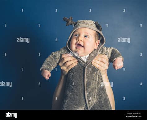 A happy little baby wearing a reindeer costume Stock Photo - Alamy