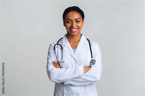 Portraif of black female doctor with stethoscope posing with crossed hands Stock Photo | Adobe Stock