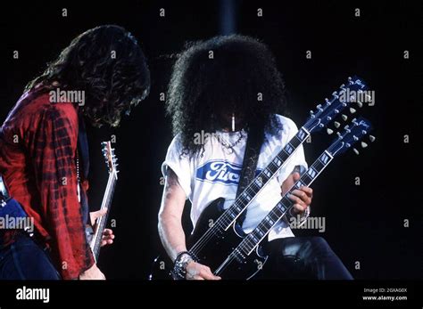 Slash from Guns and Roses playing a double guitar live in concert Stock ...