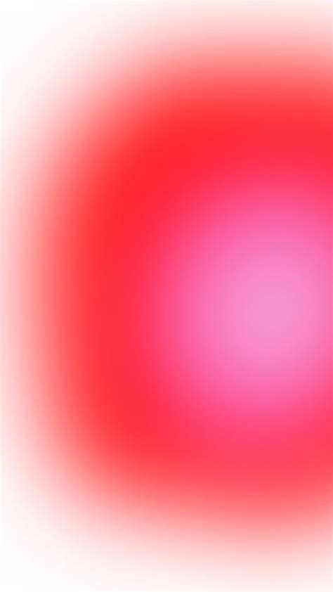 a blurry red and white background with an orange center