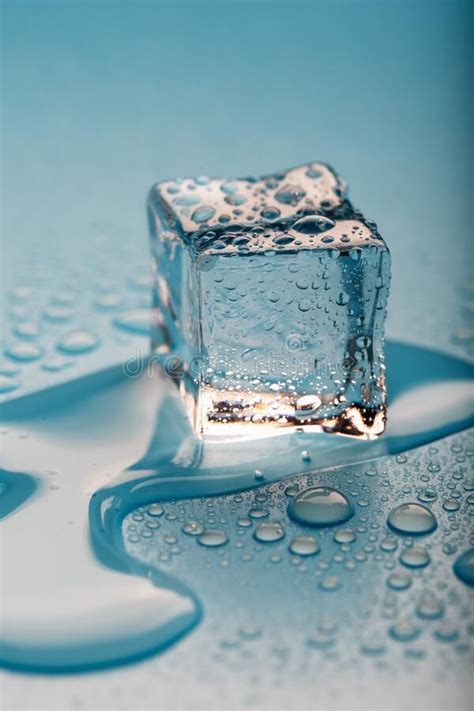 Ice Cube with Water Drops on a Blue Background. the Ice is Melting ...