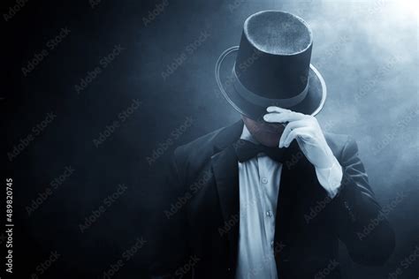 Mysterious man in black suit on dark background Stock Photo | Adobe Stock