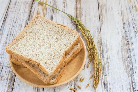 Whole wheat bread on white wooden background 6426143 Stock Photo at Vecteezy