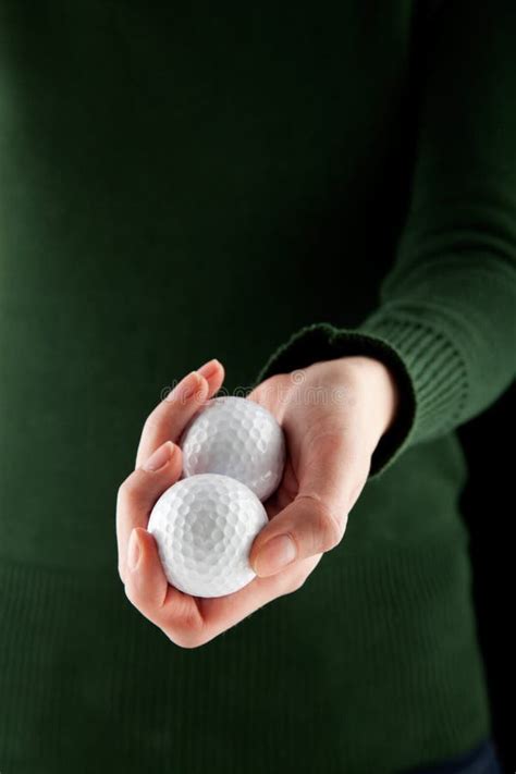 Female Hand Holding Two Golf Balls Stock Image - Image of white, ballgame: 13548063