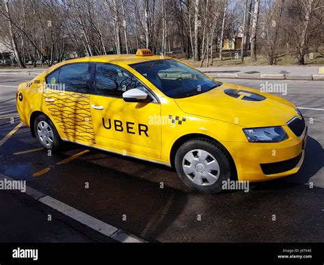 New yellow taxi with Uber logo Stock Photo - Alamy