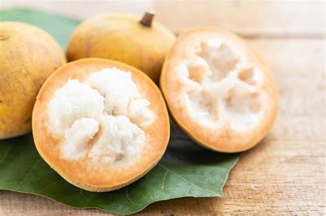 Premium Photo | Santol tropical fruit on wooden table