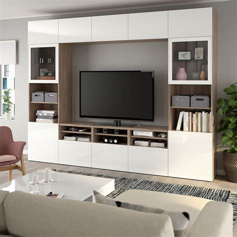 BESTÅ TV storage combination/glass doors - walnut effect light gray, Selsviken high gloss/white ...