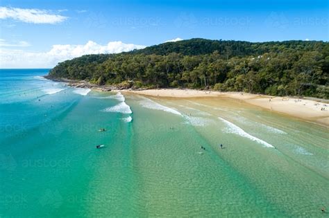 Image of Surfers and others enjoying surf at Noosa. - Austockphoto