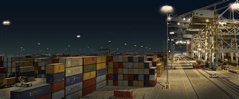 Stock Photo - Night view of shipping containers and cranes at Port of