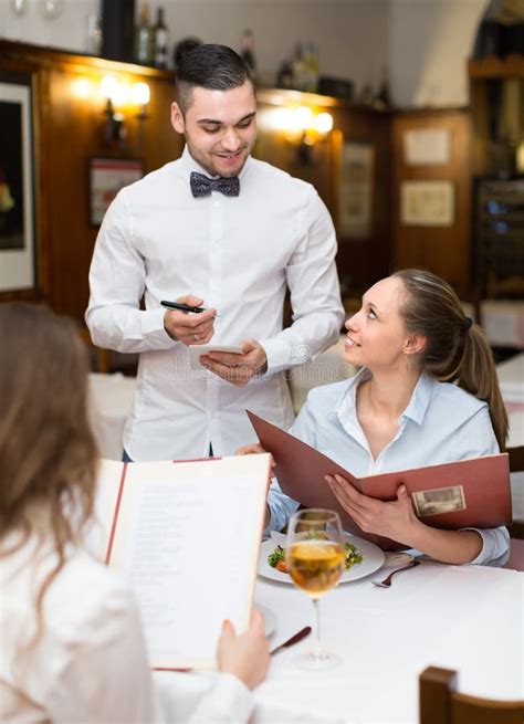 Waiter and guests in cafe stock photo. Image of plate - 60139766