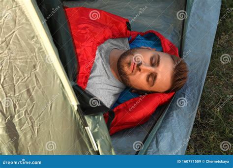 Young Man Resting in Sleeping Bag Inside Camping Tent Stock Image ...