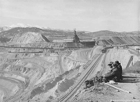 Workers sitting at edge of copper pit. Ruth, Nevada.