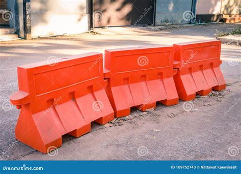 Orange Plastic Barrier Lined Up on the Road Stock Photo - Image of line ...