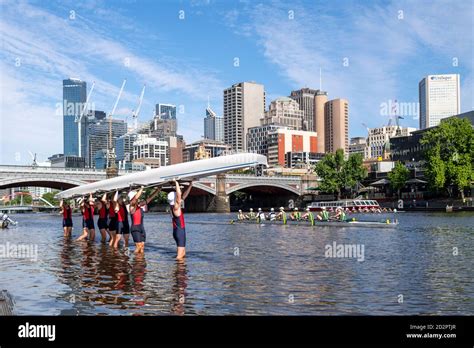 Rowers lift their boat out of the water Stock Photo - Alamy