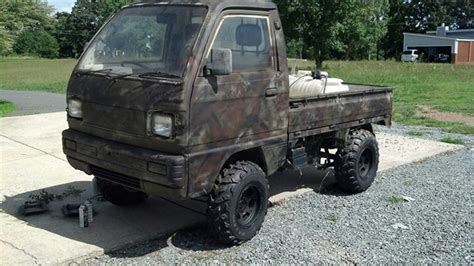 an old truck is parked in the gravel