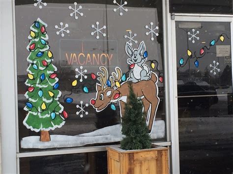 Local artist spreads Christmas cheer with festive window paintings - East Idaho News