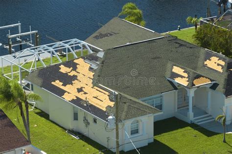 Damaged House Roof with Missing Shingles after Hurricane Ian in Florida. Consequences of Natural ...