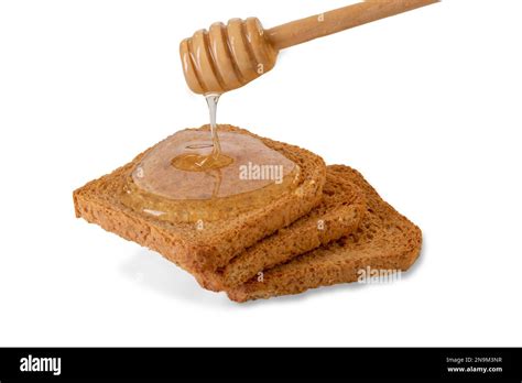 Acacia honey dripping from honey dipper on toast bread slices, isolated ...