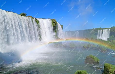 Premium Photo | Incredible rainbow over the powerful iguazu falls at ...