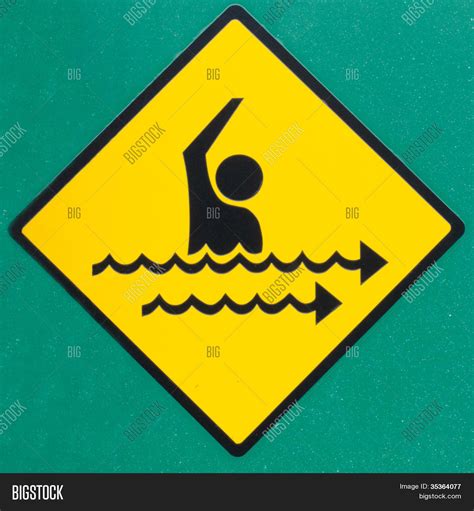 Rip current hazard symbol warning sign on green Stock Photo & Stock Images | Bigstock