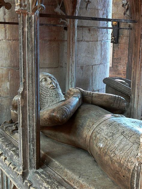 an old statue is sitting in the middle of a room with stone walls and ...