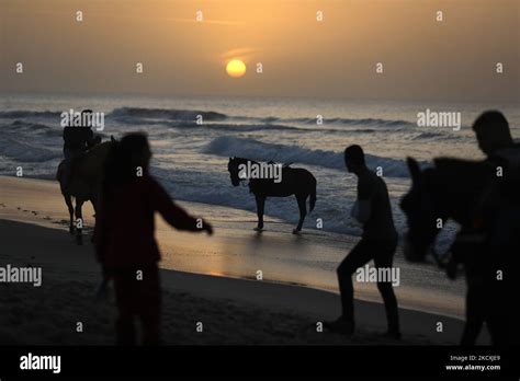 Palestinians enjoy during the sunset on the beach, in Gaza City, Dec. 10 , 2021. (Photo by Majdi ...