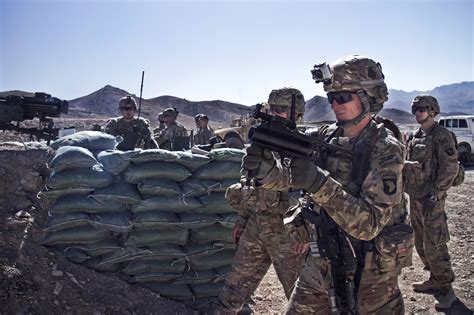 U.S. Army Maj. Kamil Sztalkoper, foreground, fires an M320 grenade ...