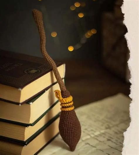 a crocheted bookmark is sitting on top of a stack of books with a rope ...