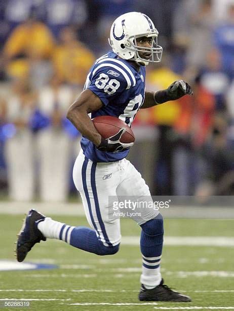 Marvin Harrison of the Indianapolis Colts runs for yardage after a... | Indianapolis colts ...