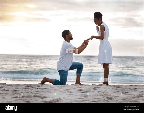 Boyfriend asking his girlfriend to marry him while standing on the ...